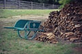 Vintage Wheelbarrow and Woodpile Royalty Free Stock Photo