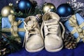 Vintage white baby shoes and blue Christmas gifts Royalty Free Stock Photo