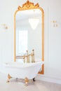 Vintage white color bathroom near mirror with a golden frame. Art deco. Luxury interior Royalty Free Stock Photo