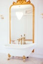 Vintage white color bathroom near mirror with a golden frame. Art deco. Luxury interior Royalty Free Stock Photo