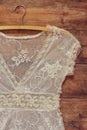 Vintage white crochet lace top with hanger on wooden background