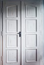 Vintage white double doors inside house. Classic wooden door Royalty Free Stock Photo