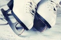 Vintage white female skates for figure skating, on a light wooden background. Royalty Free Stock Photo