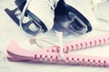 Vintage white female skates for figure skating, on a light wooden background. Royalty Free Stock Photo