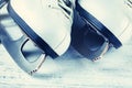 Vintage white female skates for figure skating, on a light wooden background. Royalty Free Stock Photo