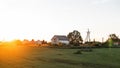 Vintage white house in the field in the village on the background the backdrop of a bright orange sunset. Rest in the countryside Royalty Free Stock Photo