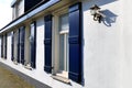 Vintage white house with open blue window shutters, lace curtain Royalty Free Stock Photo