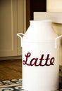 Vintage white milk can on a patterned floor