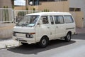 Vintage white Nissan Vanette van parked on the street near the sidewalk