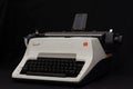 Vintage white Olympia Arabic typewriter isolated on black.