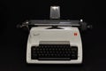 Vintage white Olympia Arabic typewriter isolated on black.