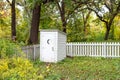 Vintage White Outhouse in Rural United States