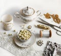 Flatlay - white and gold porcelaine table set and sewing tools Royalty Free Stock Photo