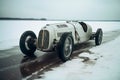 Vintage White Race Car Abandoned on Snowy Field Royalty Free Stock Photo