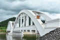 Old white arch concrete railway bridge.