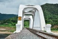 Old white arch concrete railway bridge.