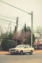 Vintage white Renault 18 is parked on a residential street, with power lines in the background