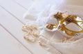 Vintage white venetian mask and pearls on toilette table Royalty Free Stock Photo