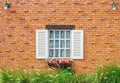 Vintage white window, flowerpot and hanging lamp on brick wall Royalty Free Stock Photo