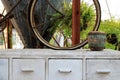 White wooden cabinet with old drum and wheel of bicycle. Royalty Free Stock Photo