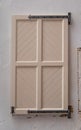 Vintage white wooden window. Antique building exterior detail. Street photo. Retro wood beige boards