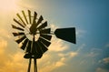 Windmill silhouette against morning sun in rural Texas