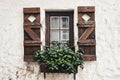 Vintage window with old wooden shutters decorated with flowers Royalty Free Stock Photo