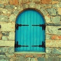 Vintage window with blue close shutters, Crete, Greece.