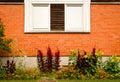 Vintage window on brick wall and garden underneath Royalty Free Stock Photo