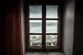 Vintage window with dramatic sea view with big stormy waves and dramatic overcast sky during rain and storm weather in fall season Royalty Free Stock Photo