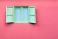 Vintage window with green shutters on pink wall Royalty Free Stock Photo