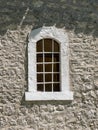 Vintage window with massive white stone blocks frame front view Royalty Free Stock Photo