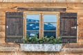 Vintage Window of old alpine house. Wooden rustic background. Royalty Free Stock Photo