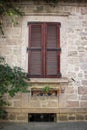 Vintage window with shutters on the wall of an old house..window in Cunda Turkey old construction and wood the historical Royalty Free Stock Photo