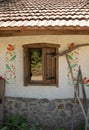 Vintage window with wooden frame and open shutters. Old house in village Reflection in window