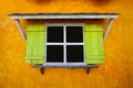 Vintage window on yellow cement wall can be used for background. Royalty Free Stock Photo