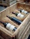 Vintage wine bottles in wooden crate with straw packaging. Royalty Free Stock Photo