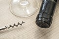 Vintage wine opener, glass and wine bottle on a wooden background Royalty Free Stock Photo