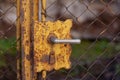 Vintage wire fence with rusty door lock, handle and keyhole Royalty Free Stock Photo