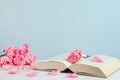 Vintage withered pink pastel rose flowers with open book Royalty Free Stock Photo