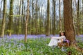 Vintage woman in bluebells forest Royalty Free Stock Photo