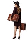 Vintage Woman carrying Luggage Profile Side View. Fashion Model in Black Hat and Dress holding Old Brown Suitcases over White Royalty Free Stock Photo