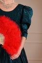 Vintage woman holding red feather fan Royalty Free Stock Photo