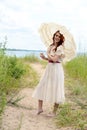 Vintage woman with parasol on beach path Royalty Free Stock Photo