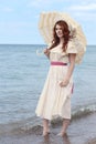 Vintage woman with parasol at the seaside Royalty Free Stock Photo