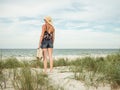 Vintage woman with a retro suitcase at baltic sea Royalty Free Stock Photo