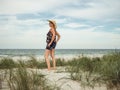 Vintage woman with a retro suitcase at baltic sea Royalty Free Stock Photo