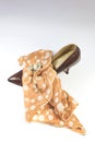 Vintage women`s snakeskin shoe, polka dot scarf, and rhinestone brooch composition on white background