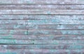 Vintage wood background with peeling turquoise old flaky paint. wall of an old house