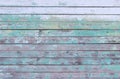Vintage wood background with peeling turquoise old flaky paint. wall of an old house